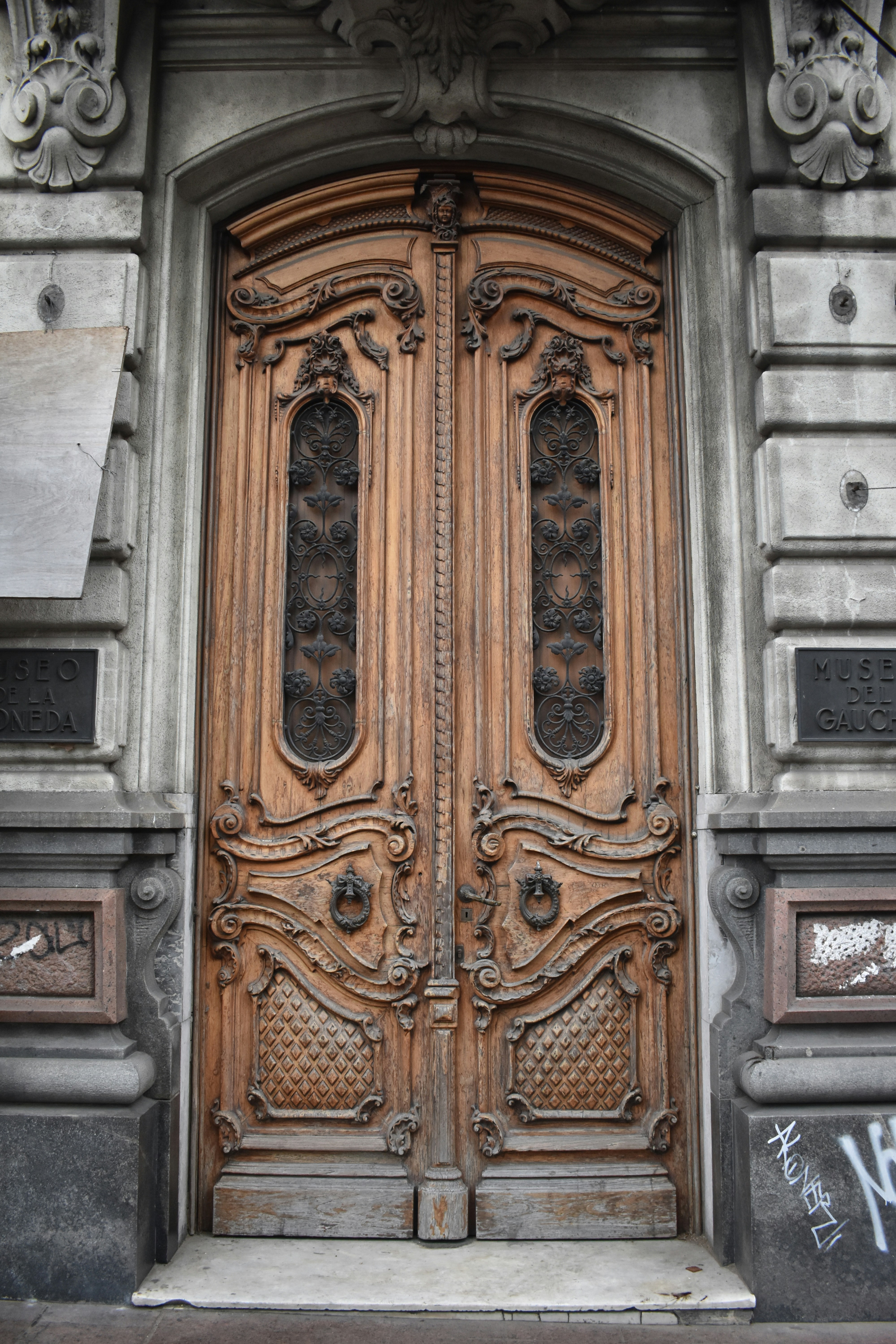 Ornate wooden double doors with intricate carvings.