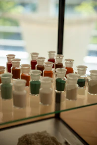 Small glass bottles filled with colorful powders.