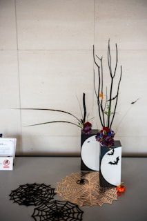 Halloween decorations with spiderwebs and bare branches.