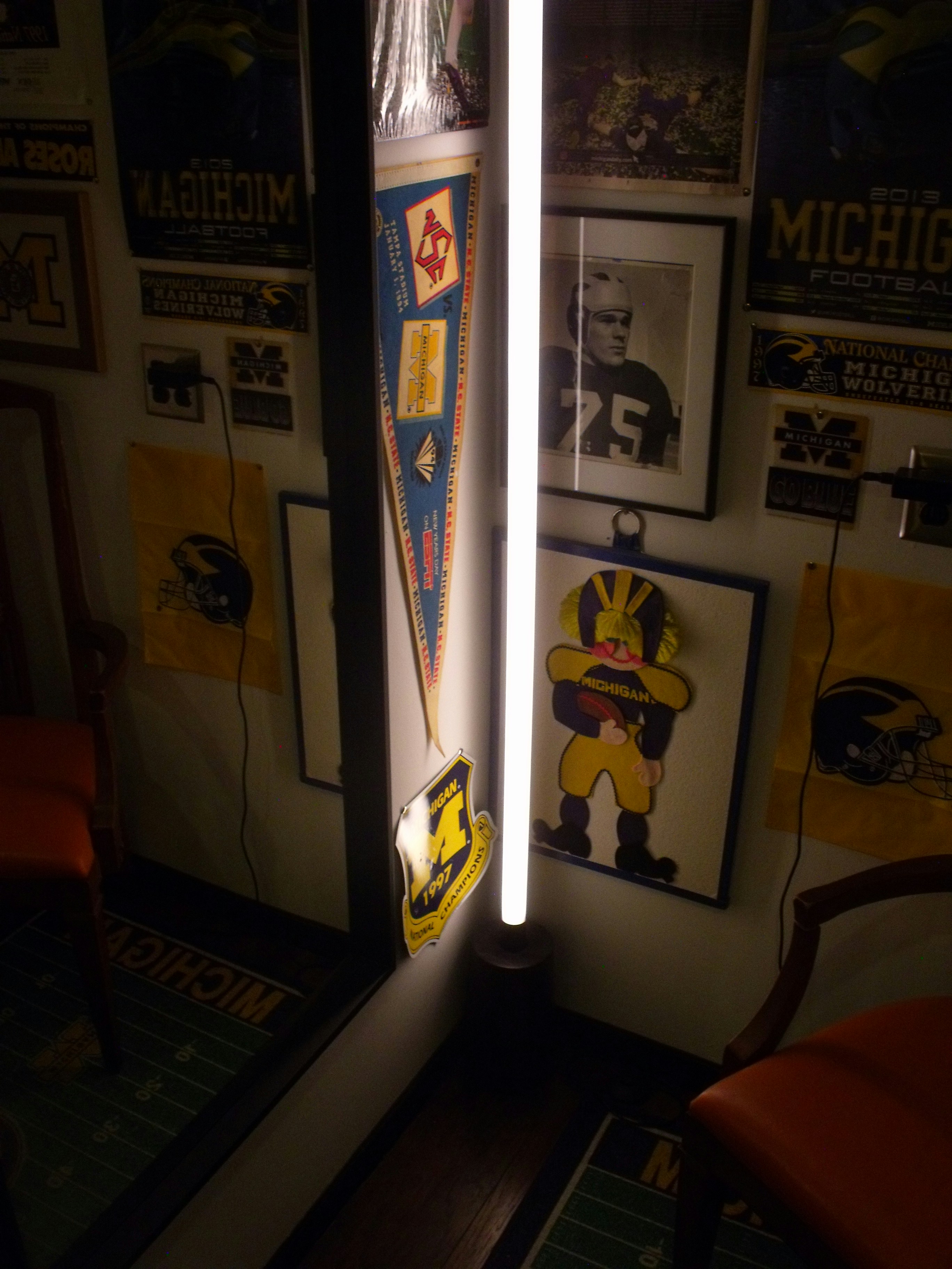 Wall decorated with michigan wolverines memorabilia and pennants