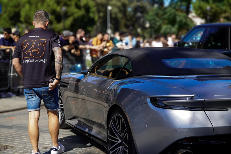 Man by luxury convertible, embodying freedom and prosperity