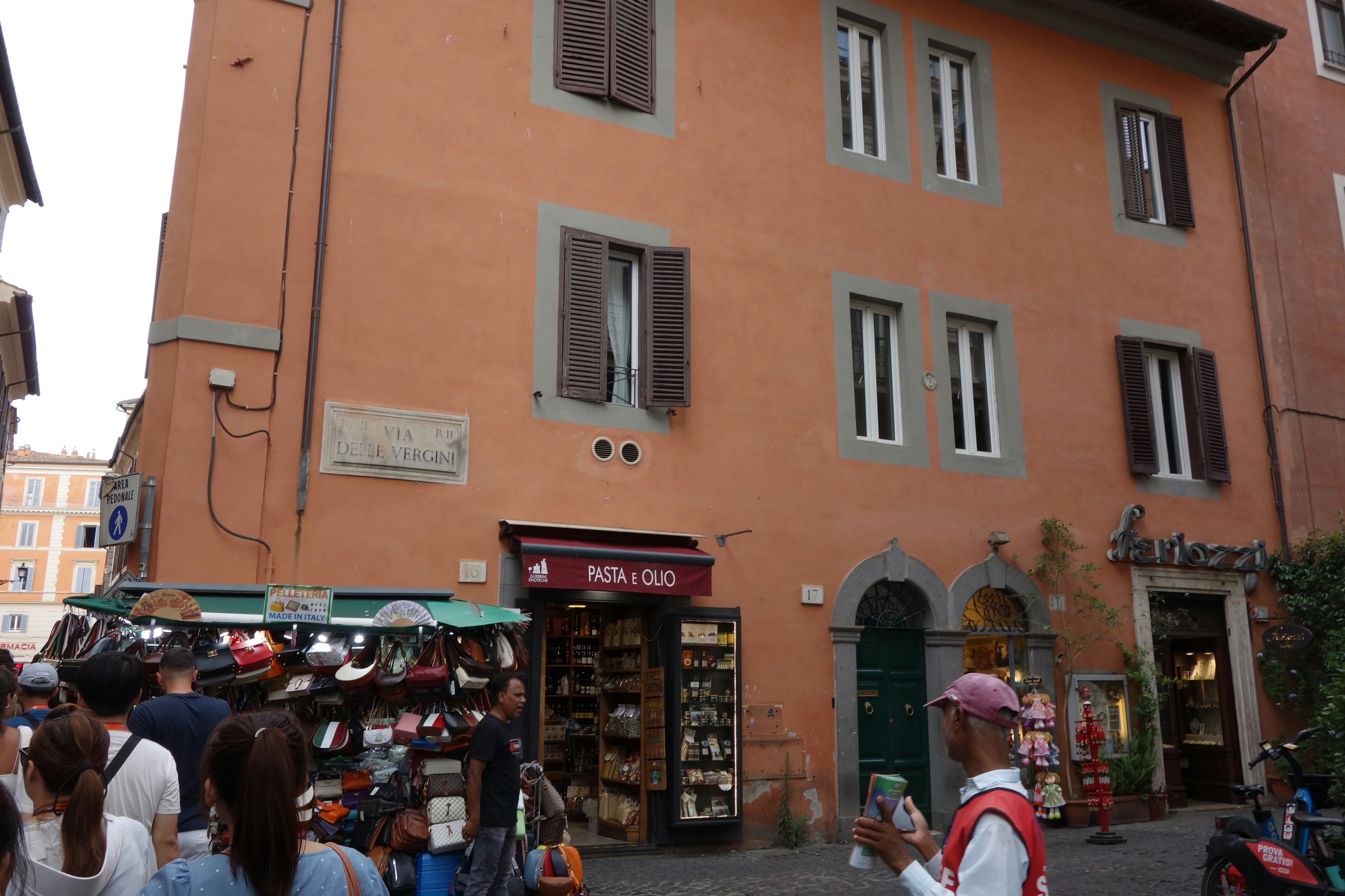 Orange building with shops and people on street