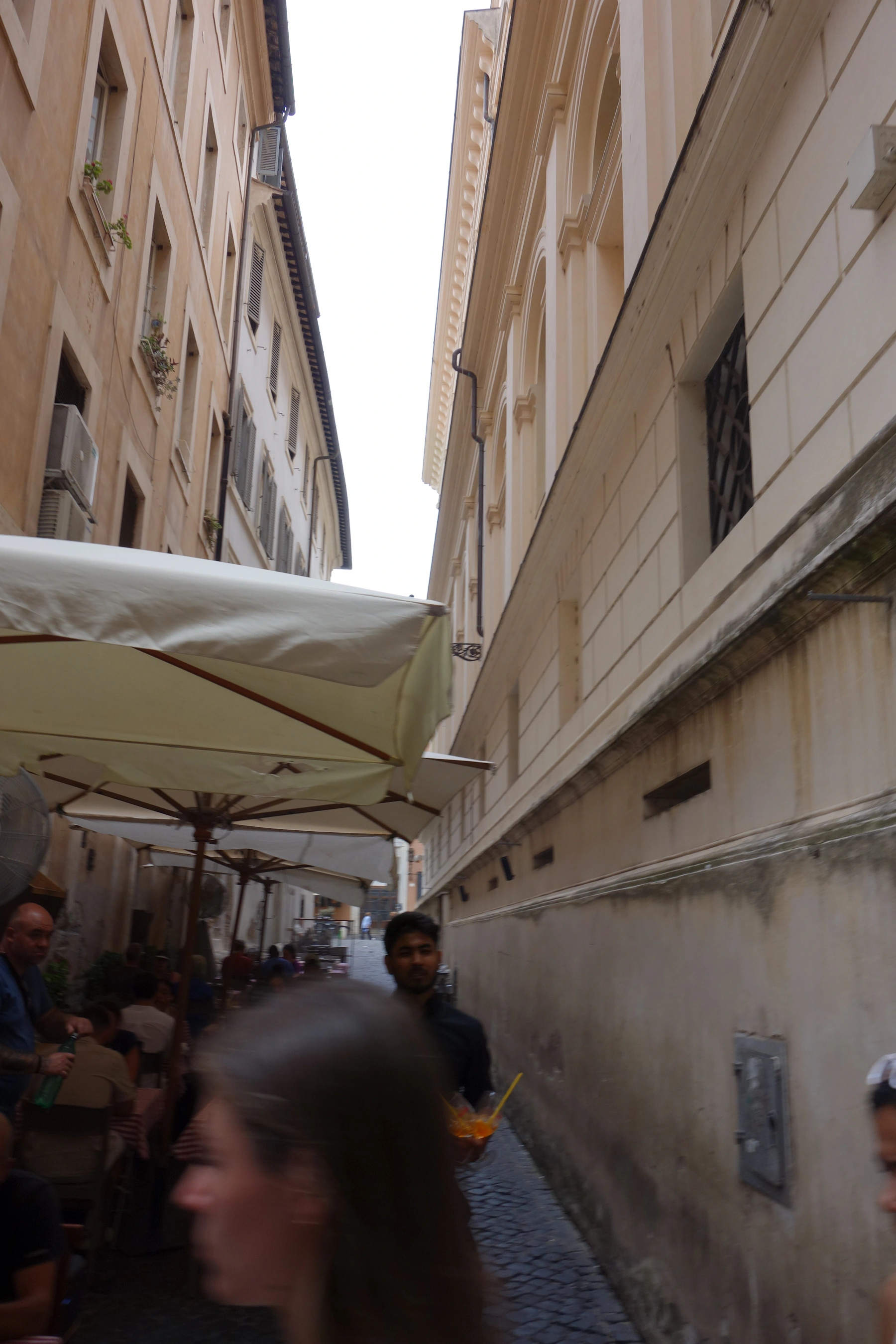 People enjoying an outdoor café on a charming European street