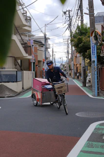 Man riding cargo bike through city street