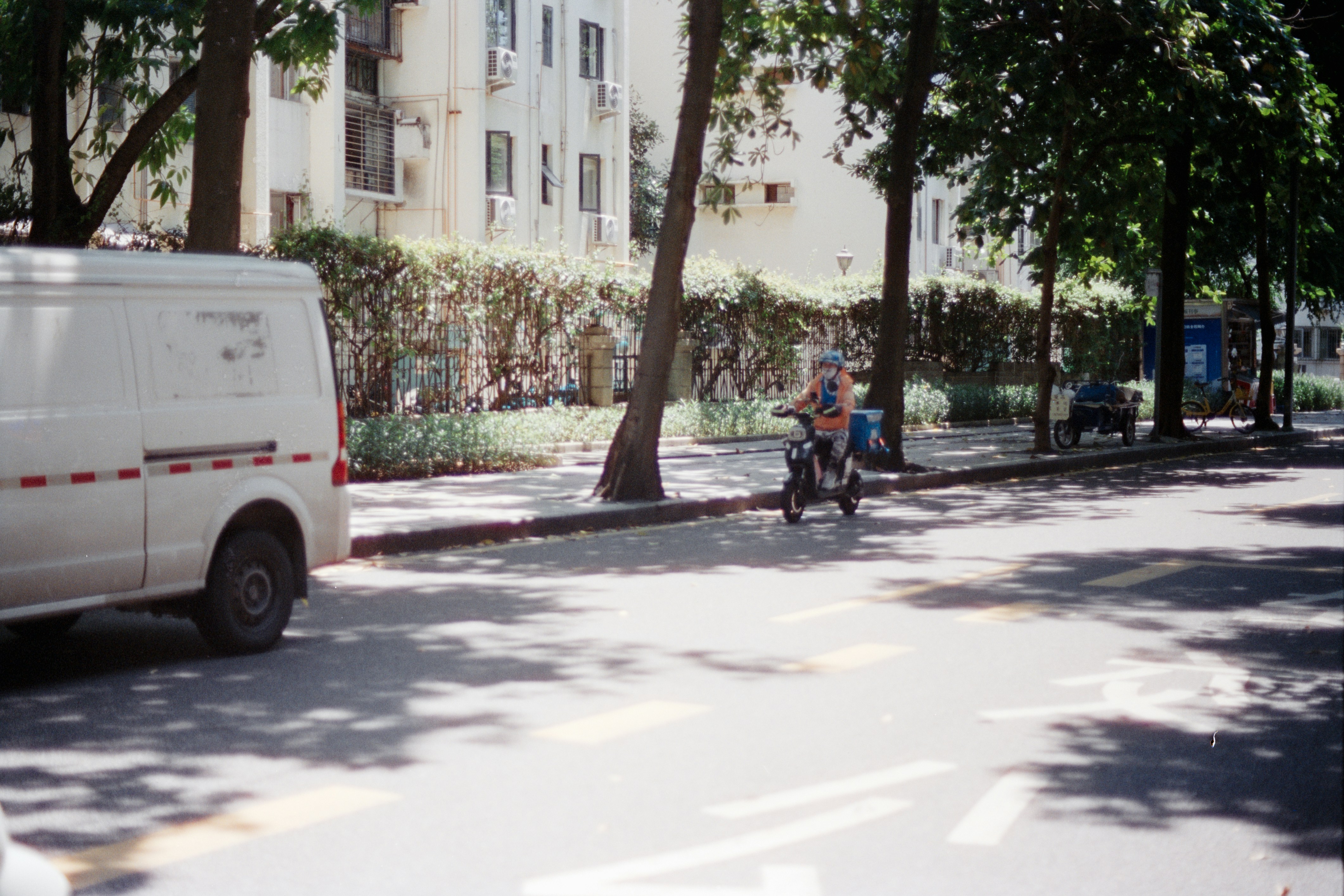 Person riding a small motorcycle on a street.