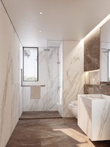 Modern bathroom with marble walls and sleek sink.