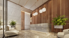 Modern lobby with marble reception desk and plants