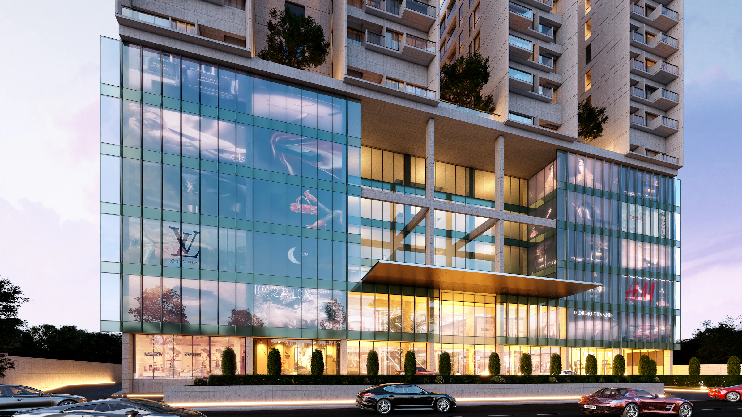 Modern glass facade with illuminated luxury storefronts at dusk