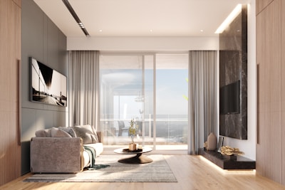 Modern living room with large window and ocean view.