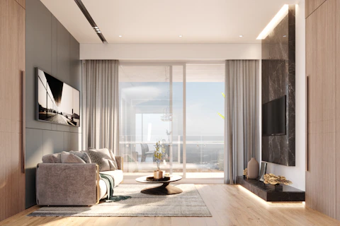 Modern living room with large window and ocean view.