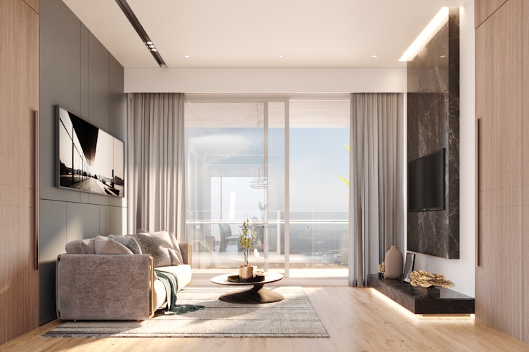 Modern living room with large window and ocean view.