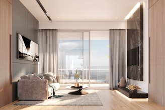 Modern living room with large window and ocean view.