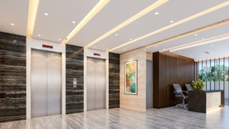 Modern lobby with elevators and reception desk.