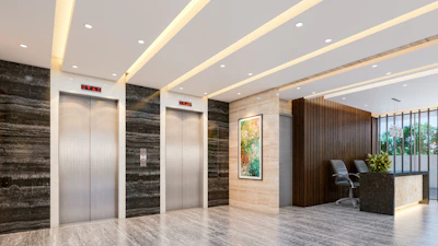 Modern lobby with elevators and reception desk.