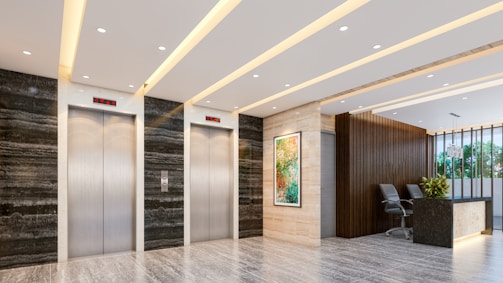 Modern lobby with elevators and reception desk.