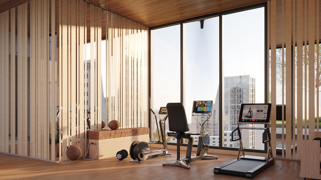 Modern gym with exercise equipment and city view
