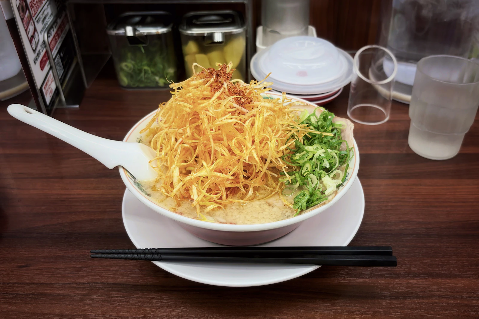 Ramen bowl topped with crispy onions and scallions