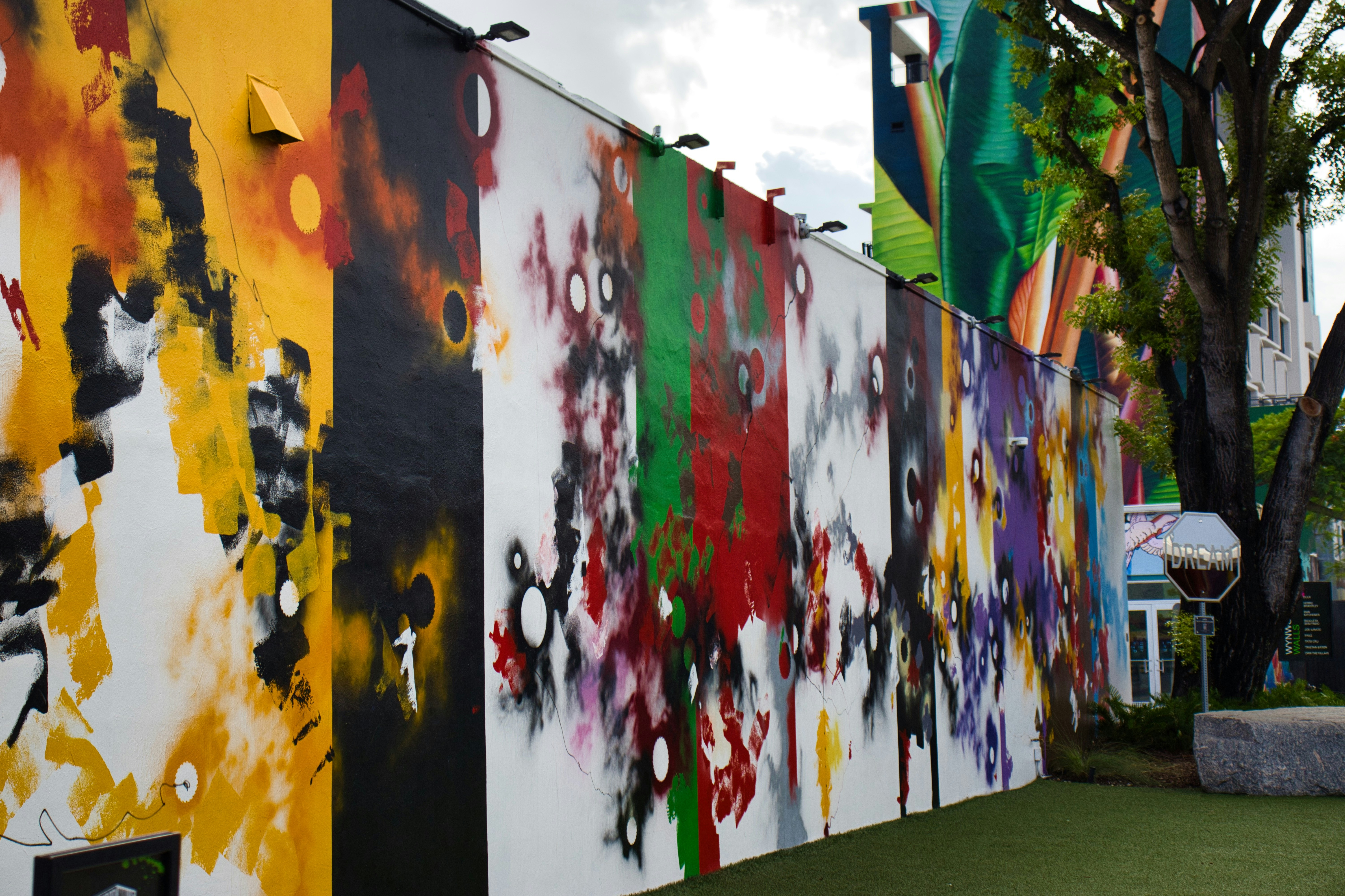 Colorful abstract graffiti art on a long outdoor wall.