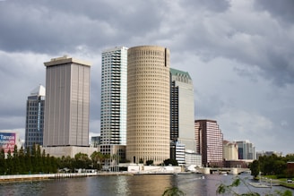 Modern cityscape with tall buildings by the water.