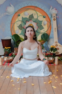 Woman meditating in a room with musical instruments.