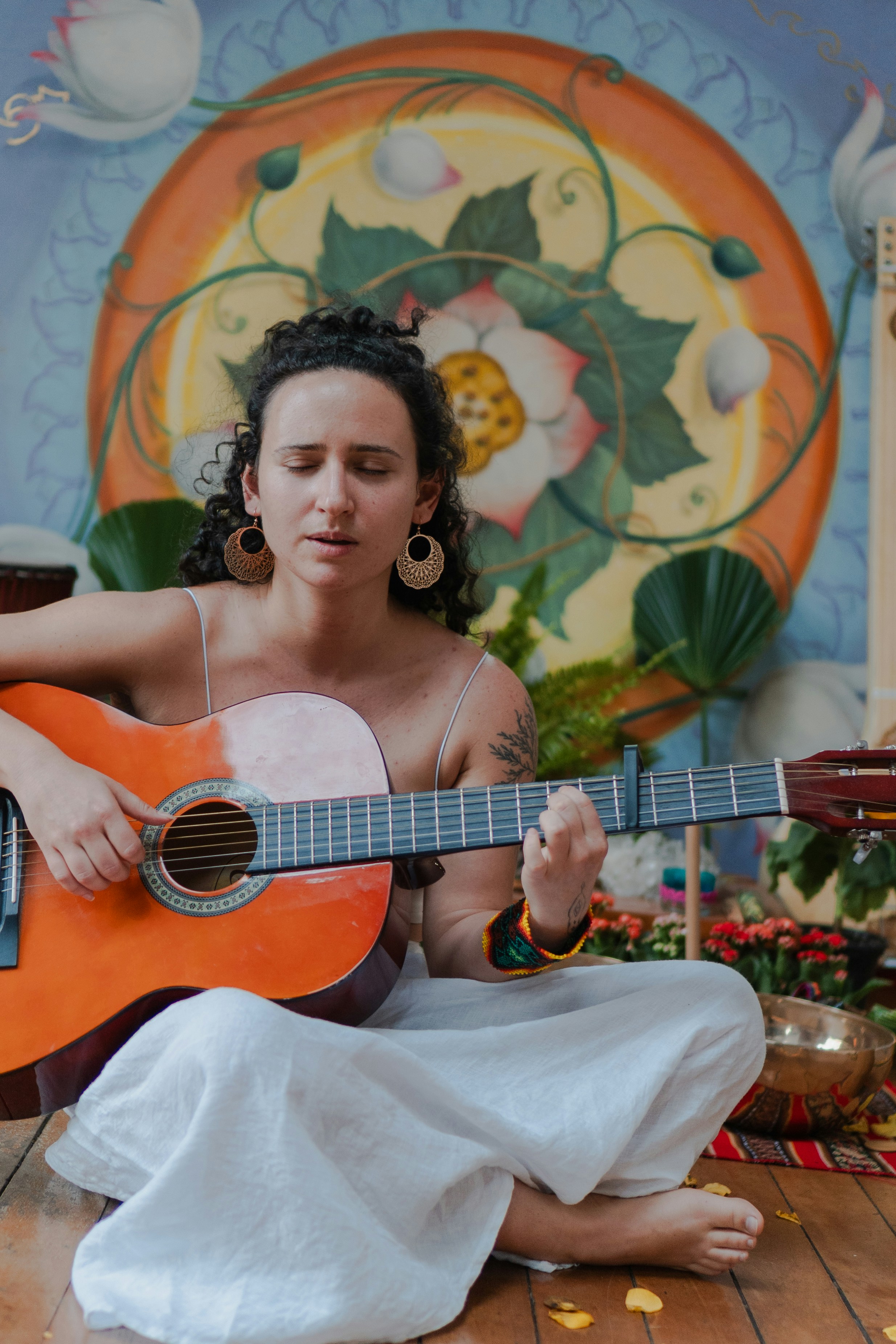 Woman playing guitar with eyes closed