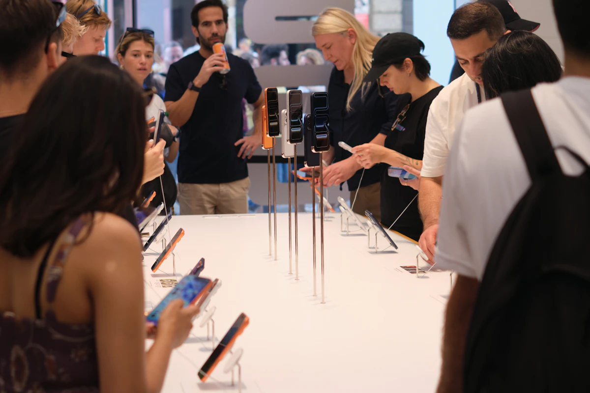 People examining smartphones displayed on a table