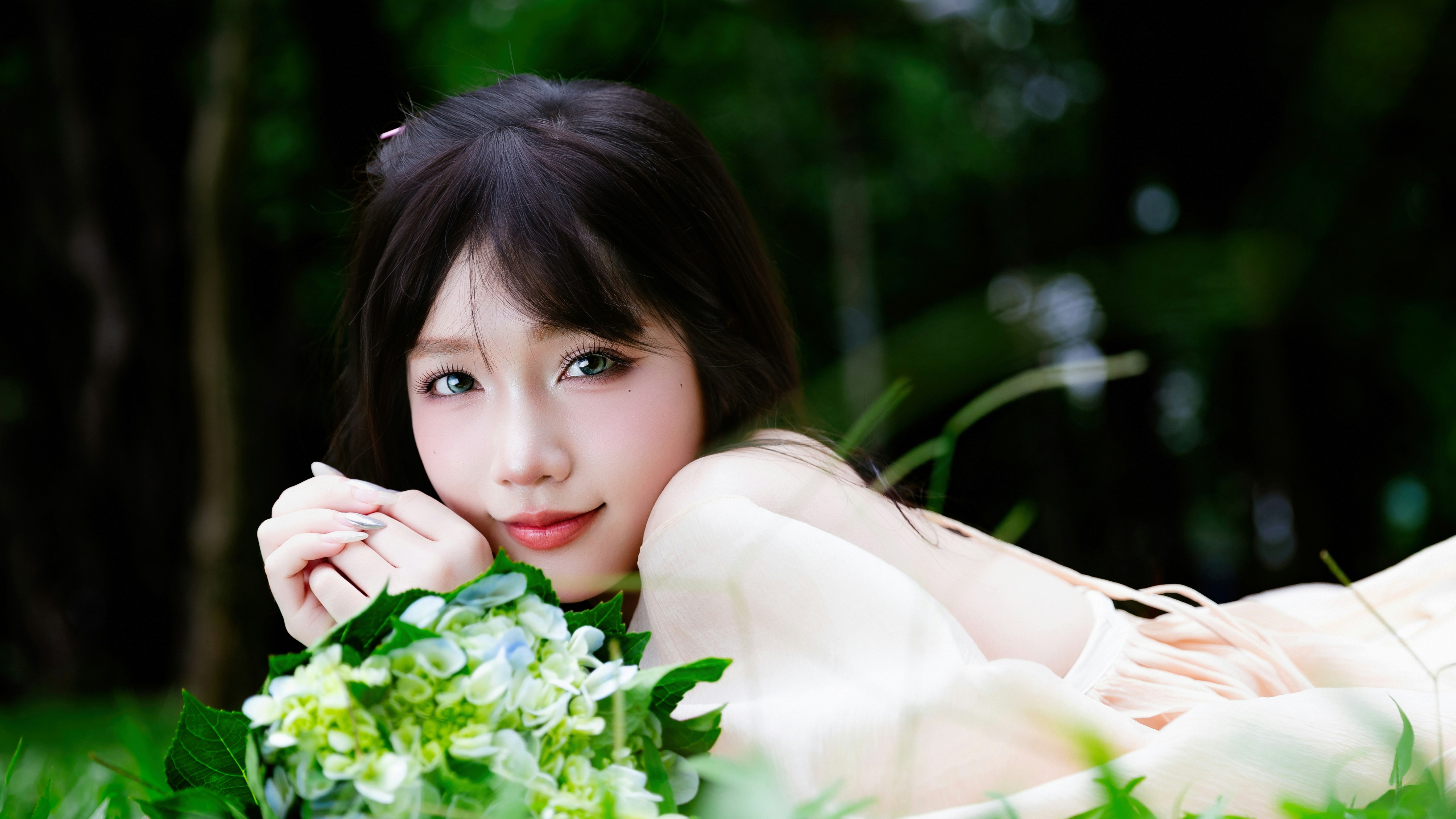 Smiling woman with hydrangea flowers