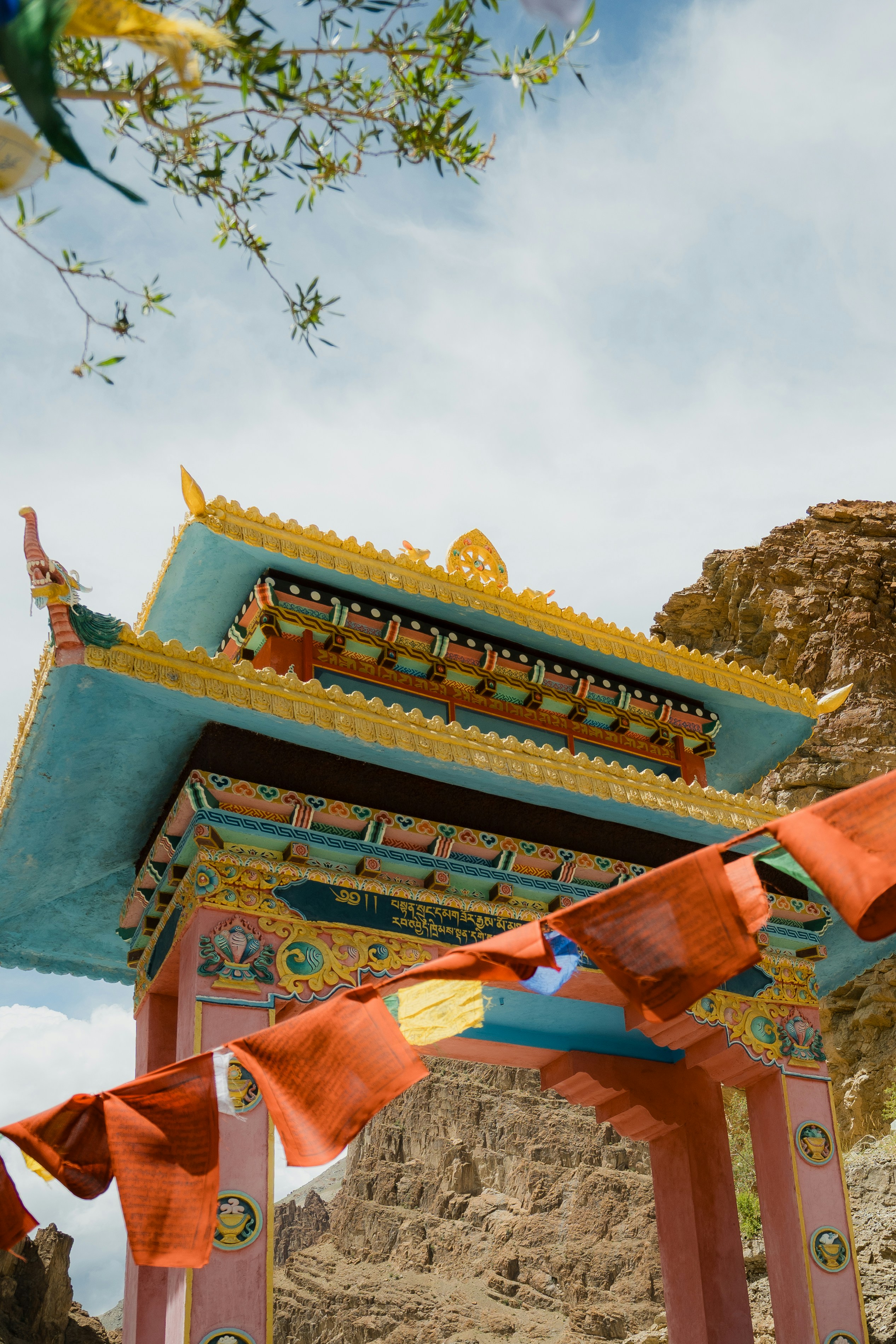 Colorful buddhist temple gate with prayer flags