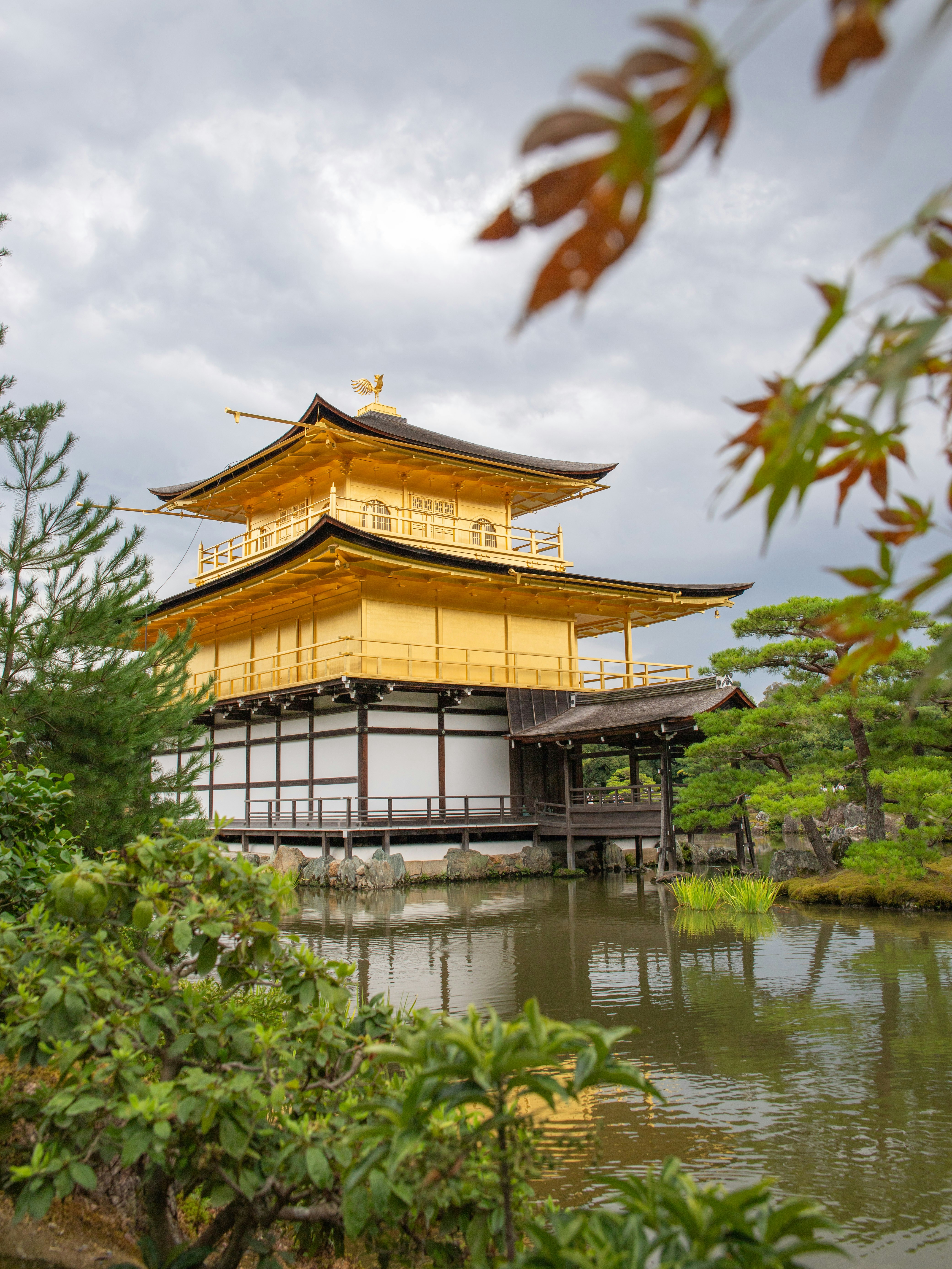 Golden pavilion temple reflected in calm water