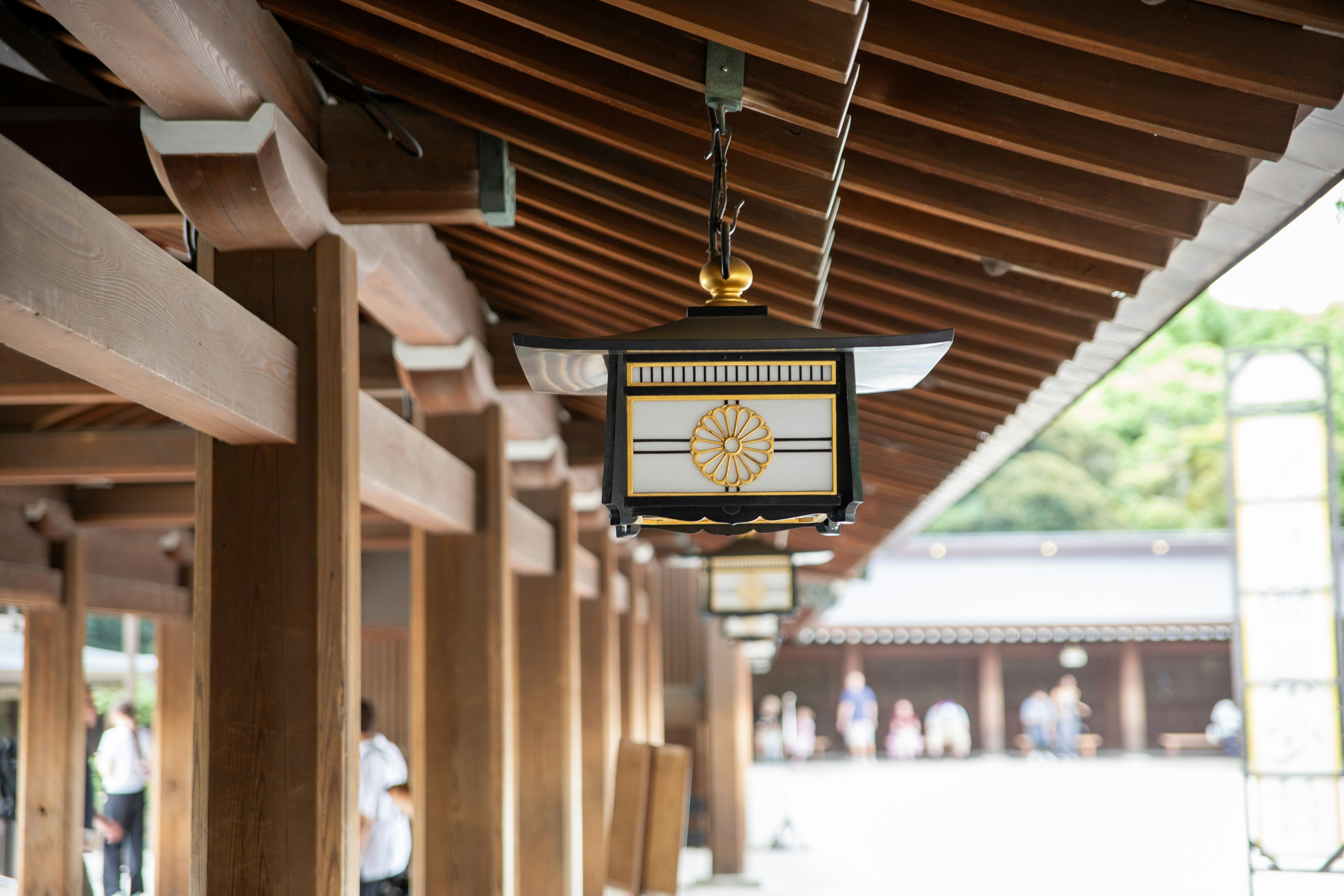 Traditional japanese lantern hanging from wooden roof