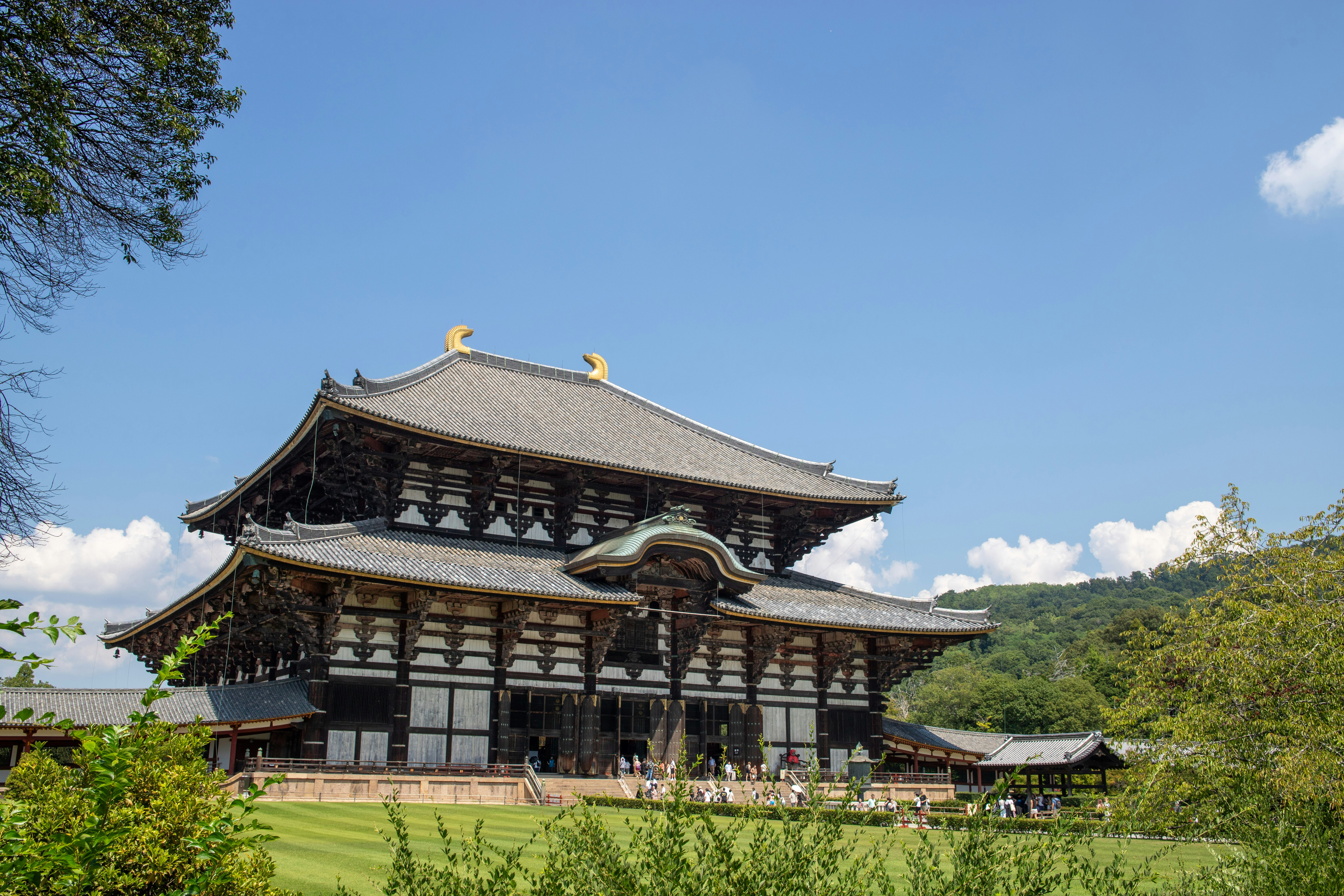 Traditional Japanese temple with ornate roof under blue sky