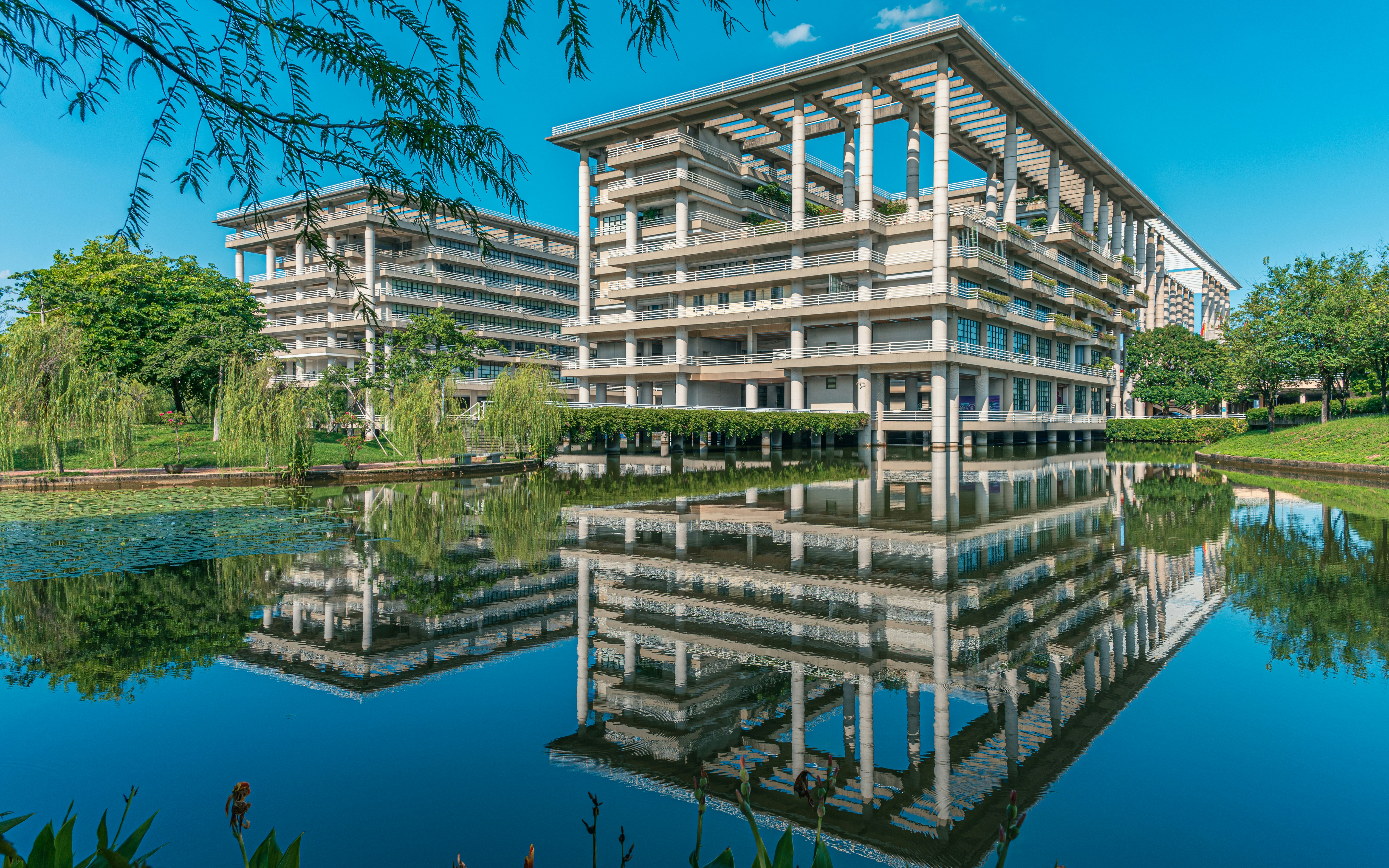Modern buildings reflected in a calm lake
