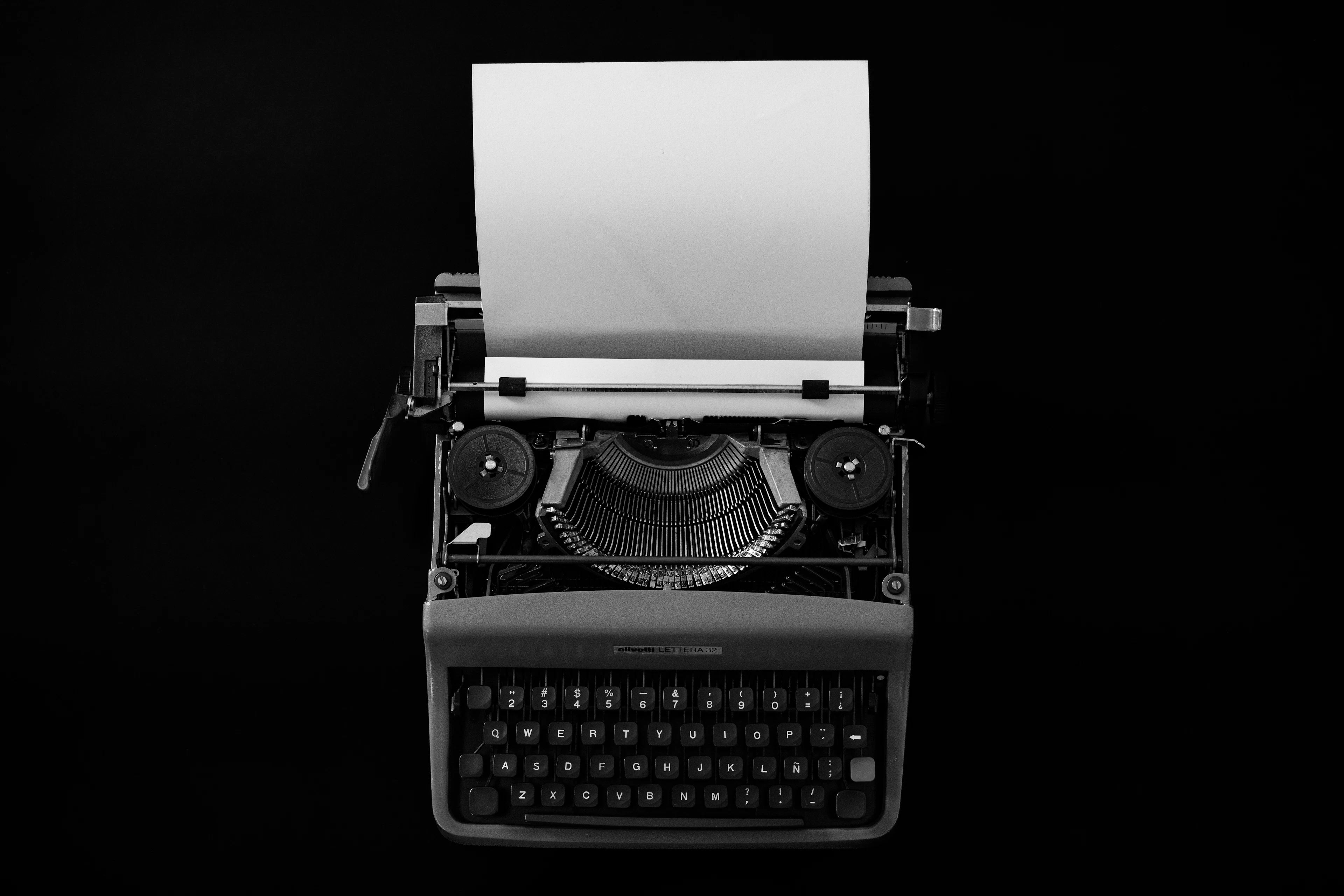 A typewriter and blank paper prepared for careful manuscript revision