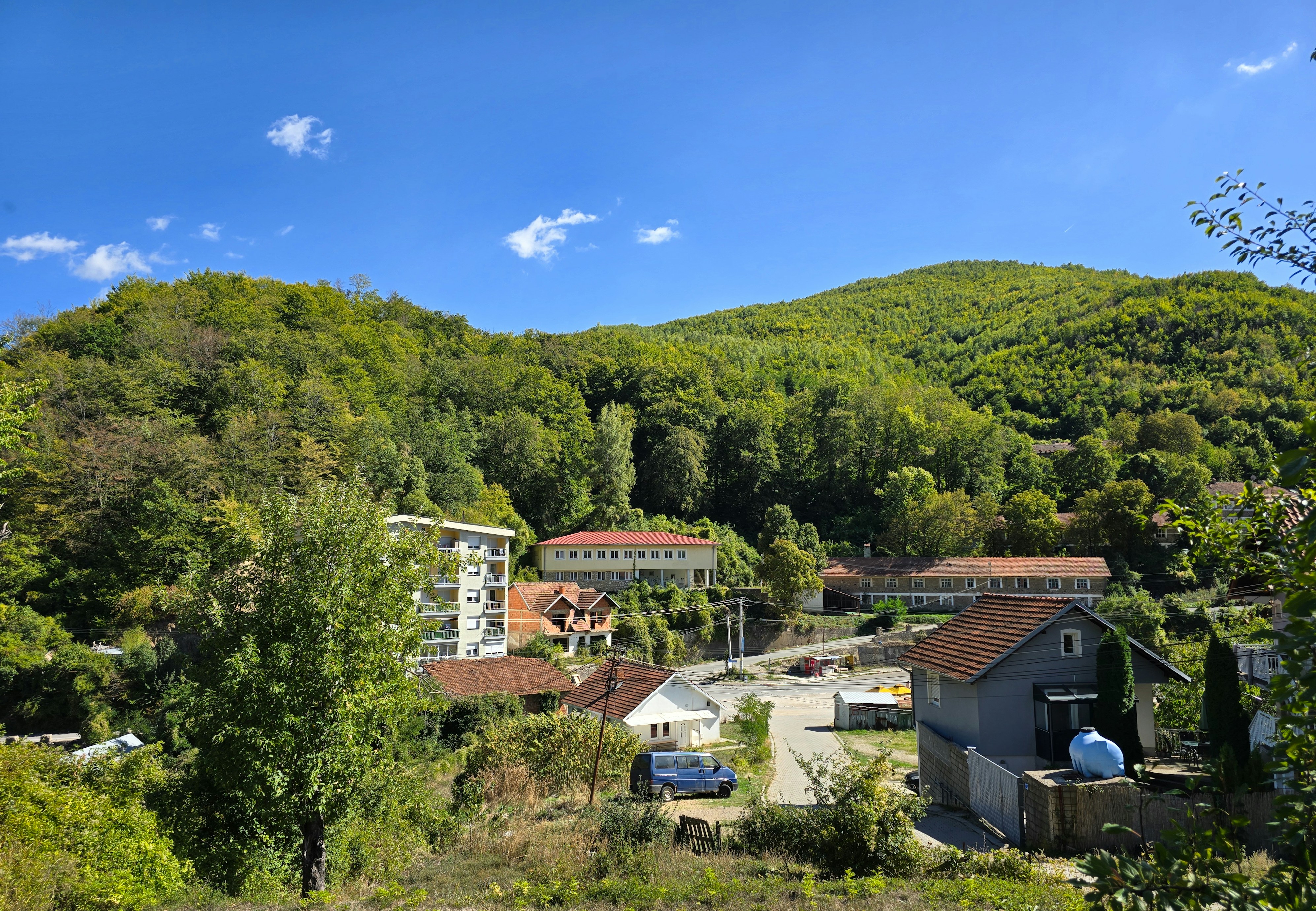 A beautiful, modern suburban home with a manicured lawn, set against a backdrop of distant mountains on a bright, sunny day, representing a desirable Castle Rock property.