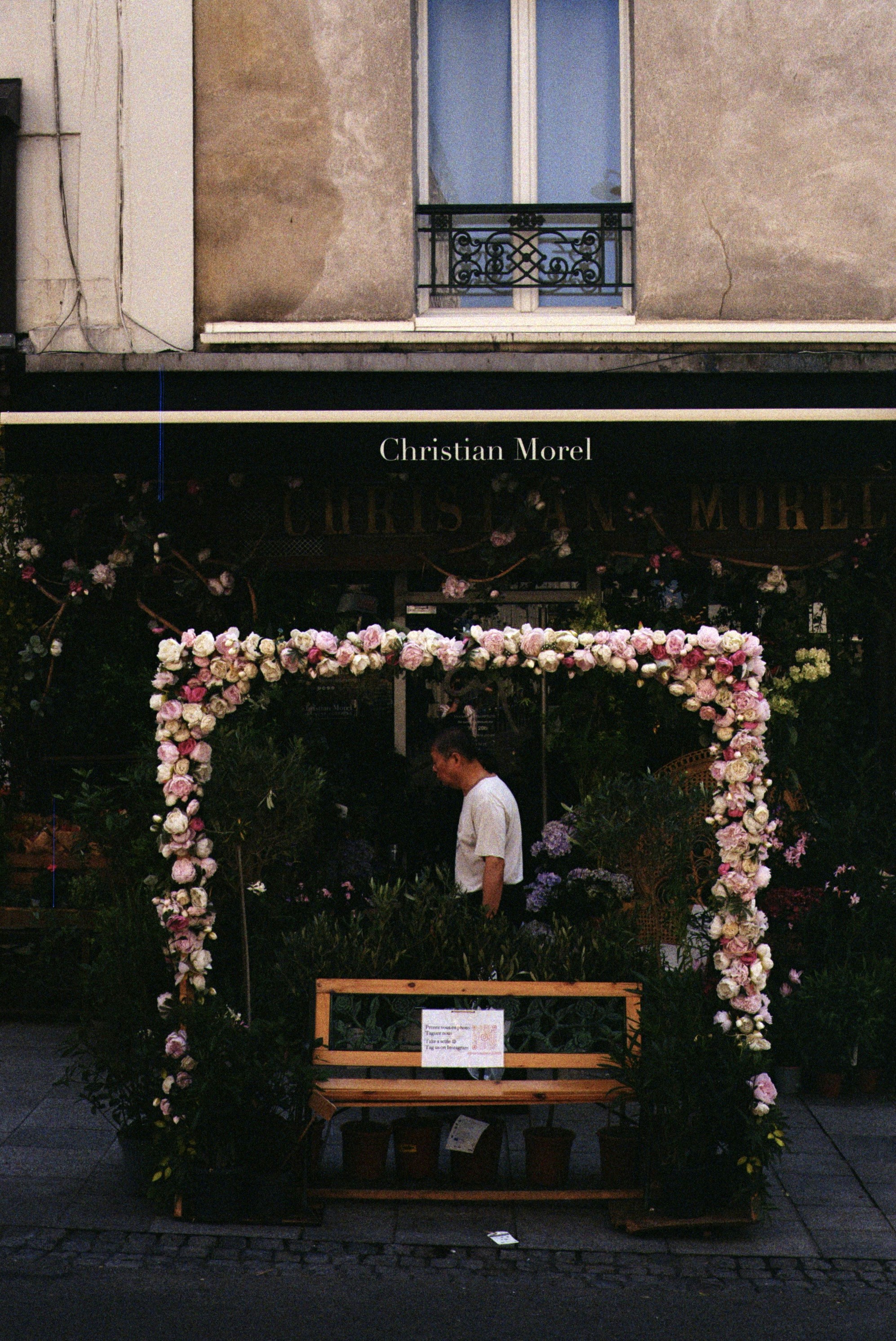 Florist shop entrance decorated with flowers and plants.