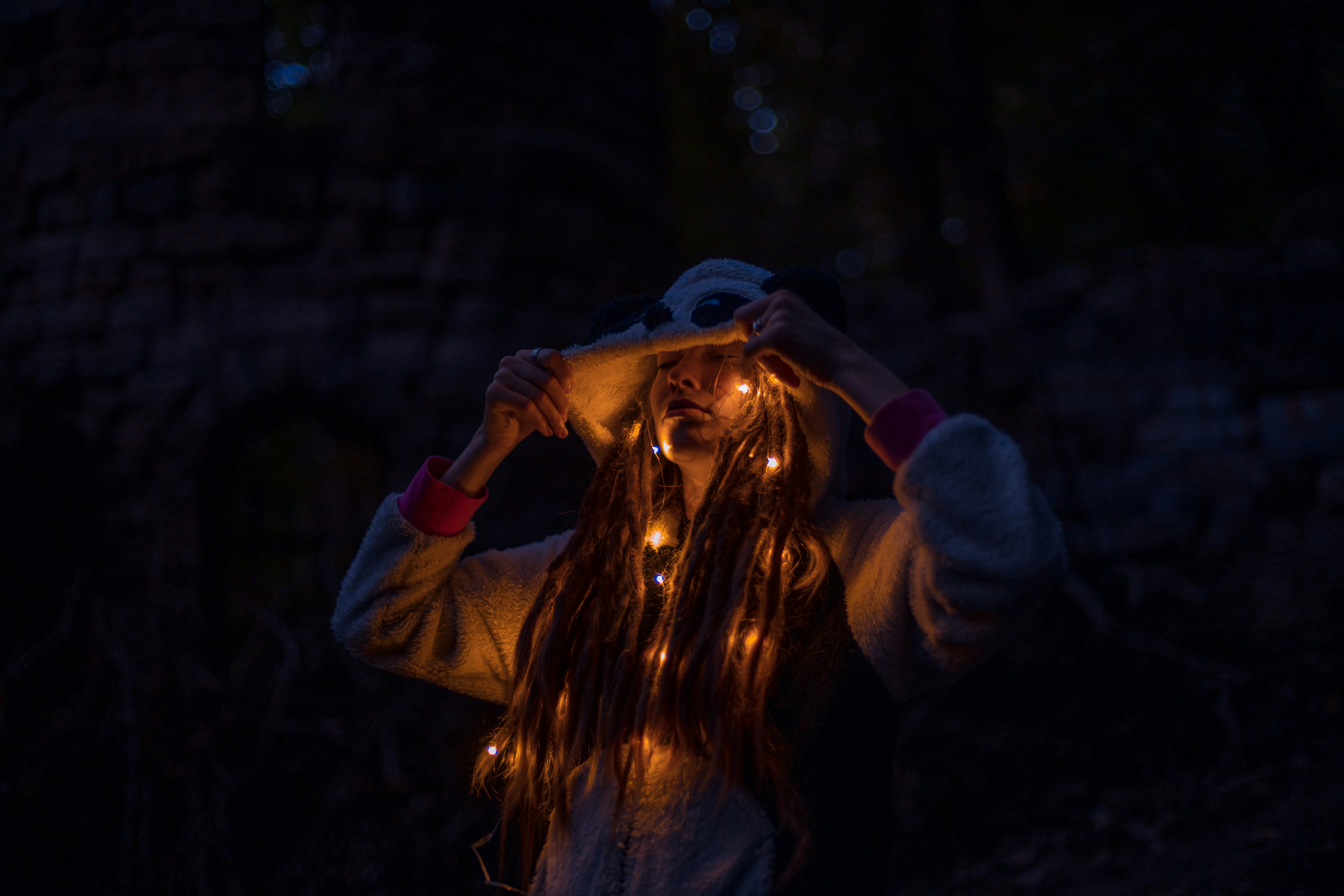 Person with fairy lights in hair at night