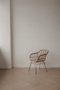 Wicker chair with metal legs on a wooden floor