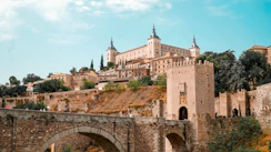 Historic castle and bridge under a blue sky