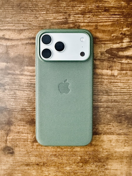 Green iPhone case with apple logo on wood