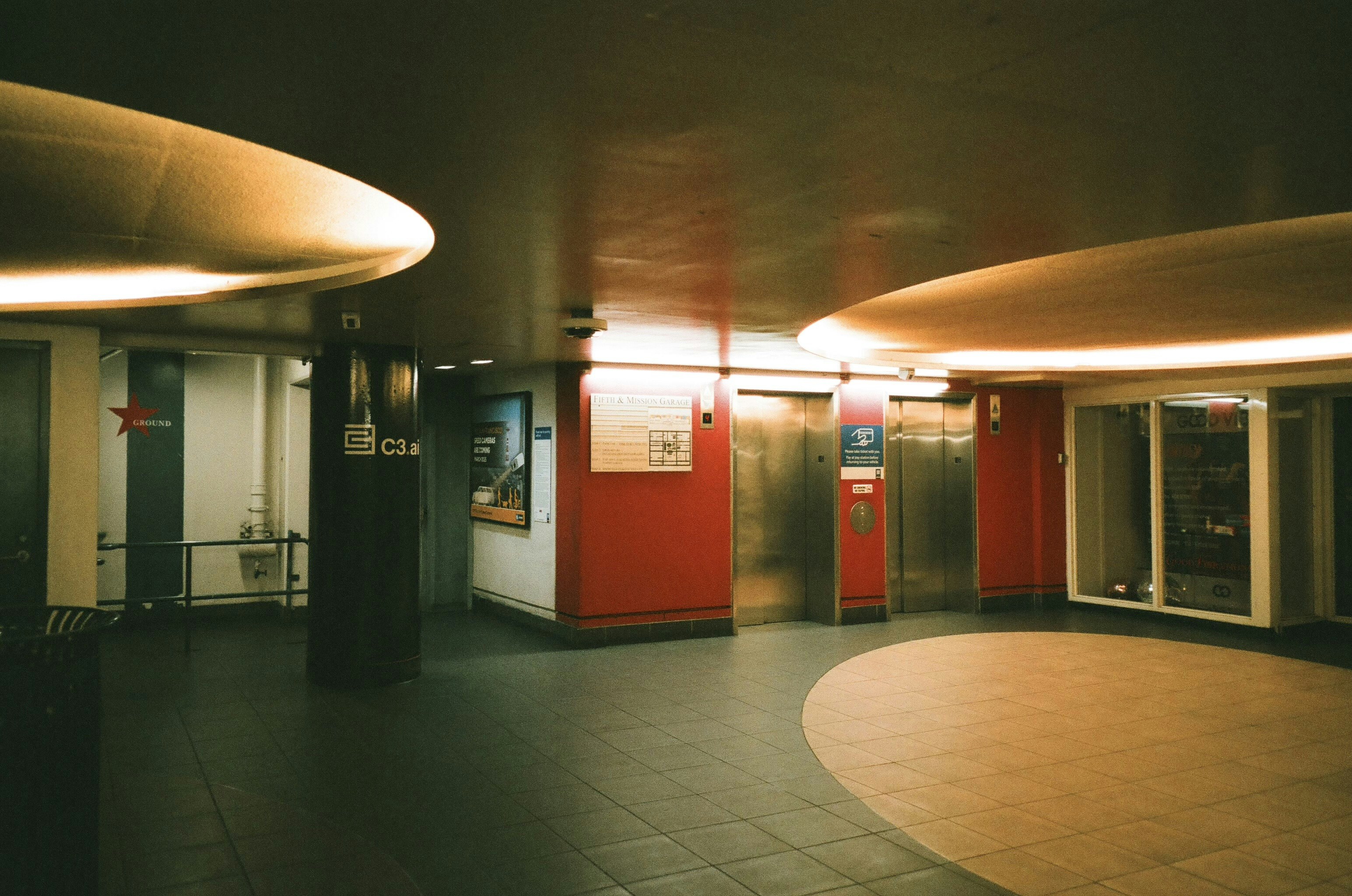 Modern elevator lobby with curved ceiling lights