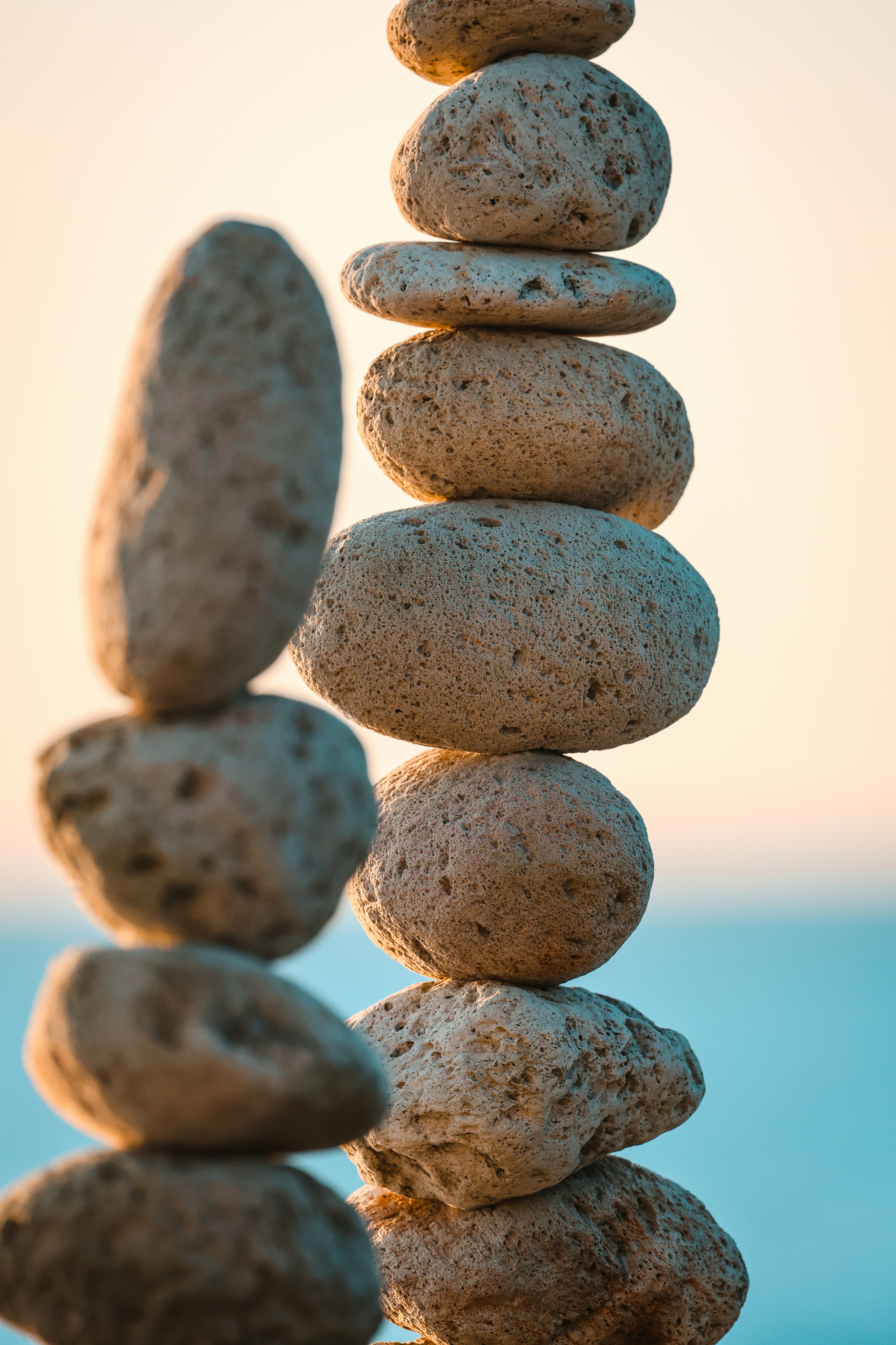 Stack of smooth stones balanced against a soft sky