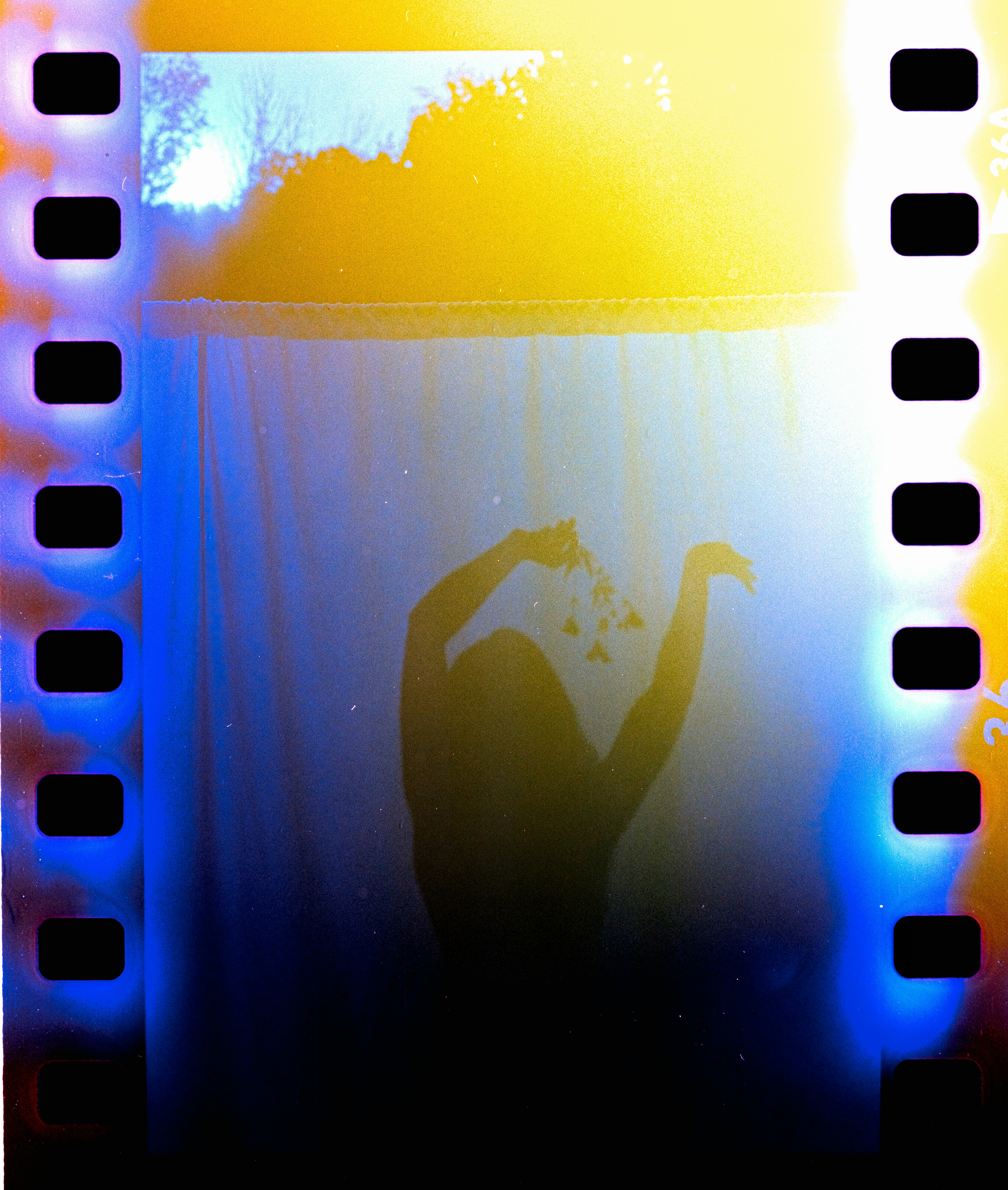Silhouette of a person holding glowing objects
