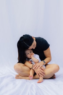 Mother holding her baby on a white background