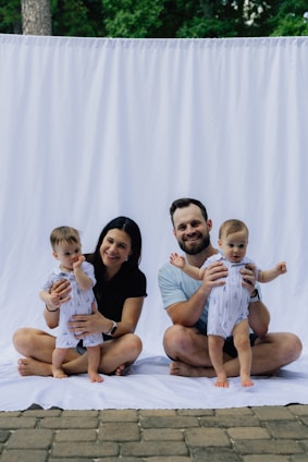Family with two babies posing for a portrait