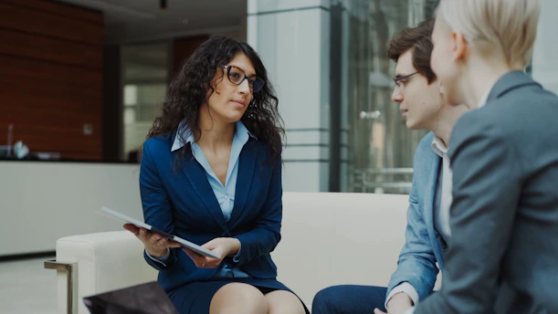Three professionals in a business meeting discussion