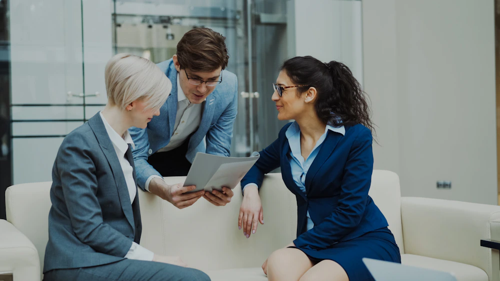 Business professionals discussing documents in a meeting.