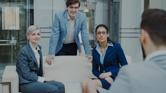 Four business professionals in a modern office meeting