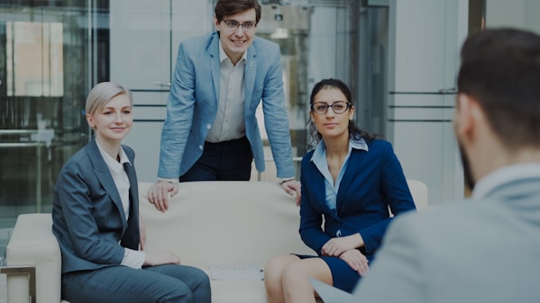 Four business professionals in a modern office meeting