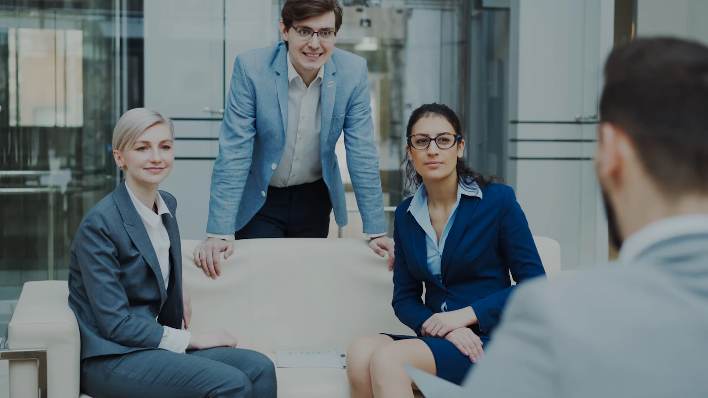 Business professionals discussing a project during a client meeting