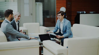 Three business people in a modern office meeting